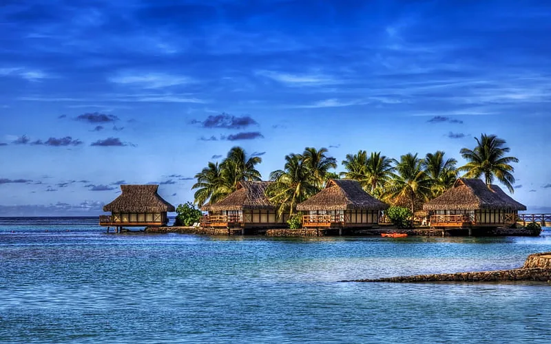 Maldives – overwater bungalows with palm trees and turquoise lagoon